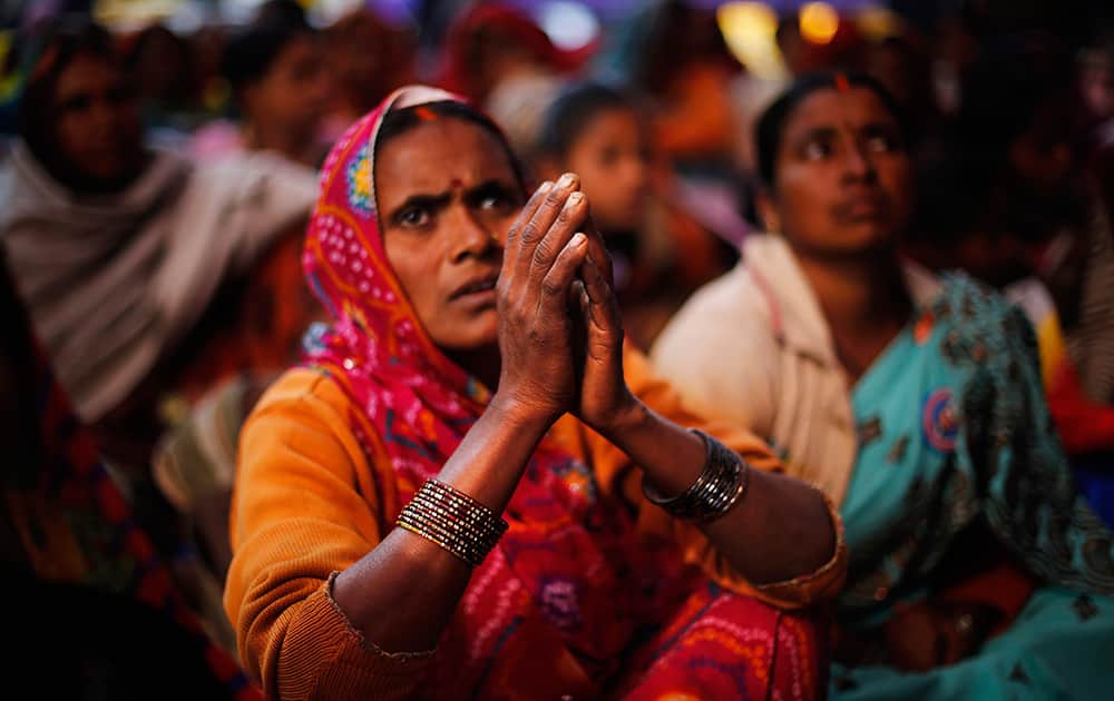 A Dalit woman, member of the outcast community once known as untouchables, listens to a speaker with folded hands at a sit in protest on Human Rights Day near the Indian Parliament in New Delhi.