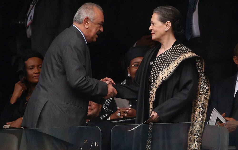 Sonia Gandhi is greeted as she arrives for the memorial service for former South African president Nelson Mandela at the FNB Stadium in Soweto near Johannesburg.
