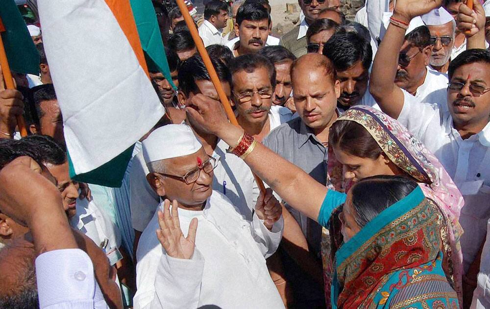 Social activist Anna Hazare with suuporters before launching his indefinite hunger strike for Jan Lokpal Bill, at his village in Ralegan Siddhi in Ahmednagar district.