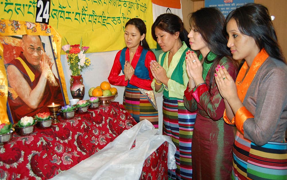 Tibetan refugees offering prayers for the long life of Dalai Lama on the 24th anniversary of Dalai Lama’s Nobel Peace Prize award in Bhopal.