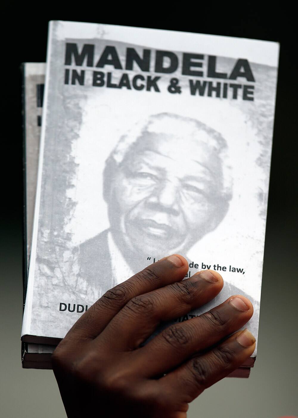 Mourners from Nigeria, sing outside the home of former president Nelson Mandela in Johannesburg.