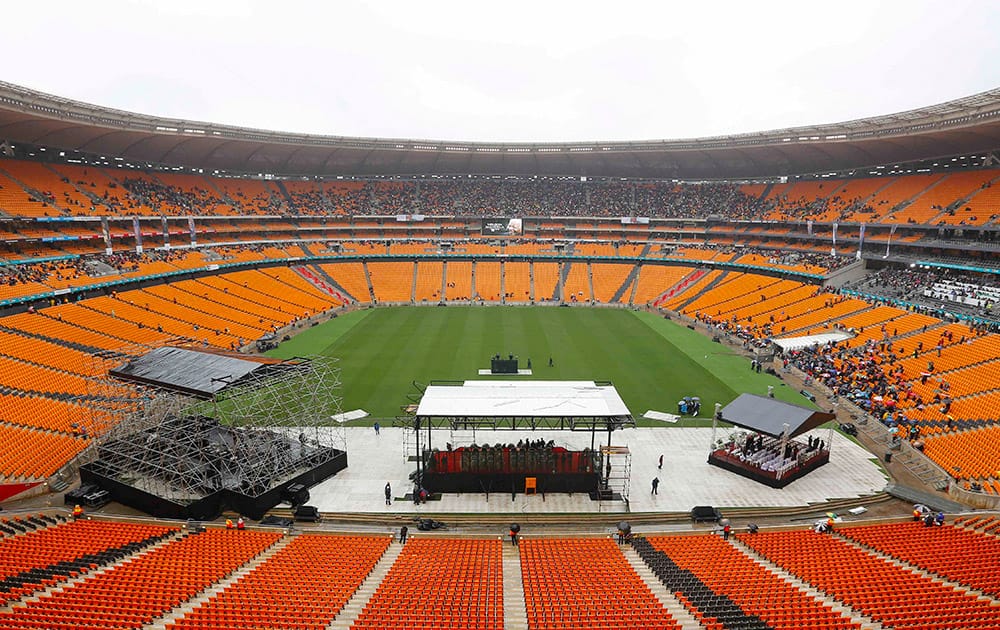 Early arrivals take their seats ahead of the memorial service for former South African president Nelson Mandela at the FNB Stadium in Soweto, near Johannesburg, South Africa.