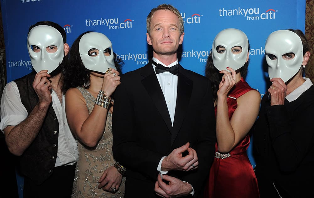 Neil Patrick Harris poses with `Sleep No More` cast members during an exclusive event for Citi ThankYou customers at The McKittrick Hotel, home of `Sleep No More,` in New York.
