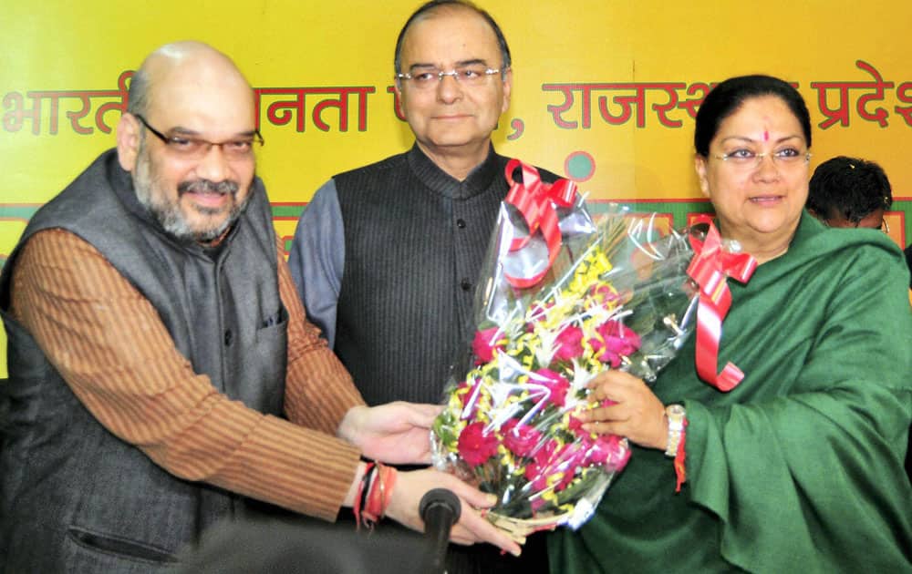 Rajasthan BJP President Vasundhara Raje being greeted by party`s Senior leader Arun Jaitley and Amit Shah during meeting at Party office for electing new Chief Minister of Rajasthan in Jaipur.