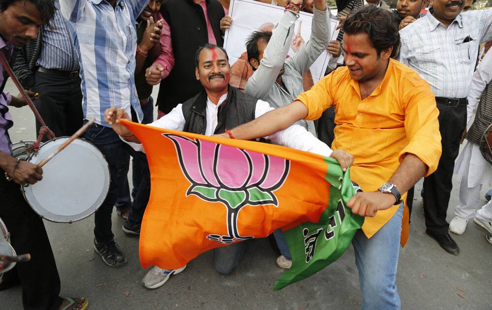 India’s main opposition Bharatiya Janata Party (BJP) supporters celebrate the party’s victory in various state Assembly elections in Allahabad.