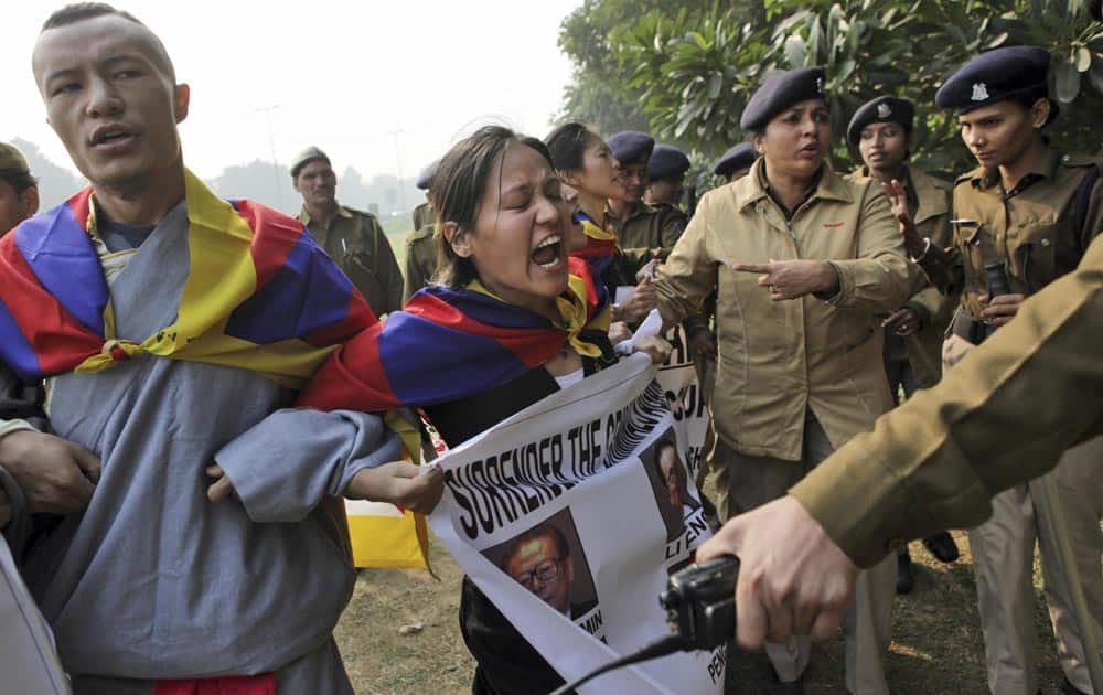 An exile Tibetan raises slogans during a protest against the alleged human rights abuses of Tibetans by the Chinese government outside the Chinese embassy on the eve of World Human Rights Day in New Delhi.