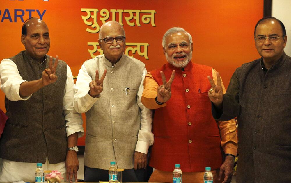 India’s main opposition Bharatiya Janata Party (BJP) leaders, Rajnath Singh, Lal Krishna Advani, Narendra Modi, and Arun Jaitley, flash victory signs at the party’s head office in New Delhi.