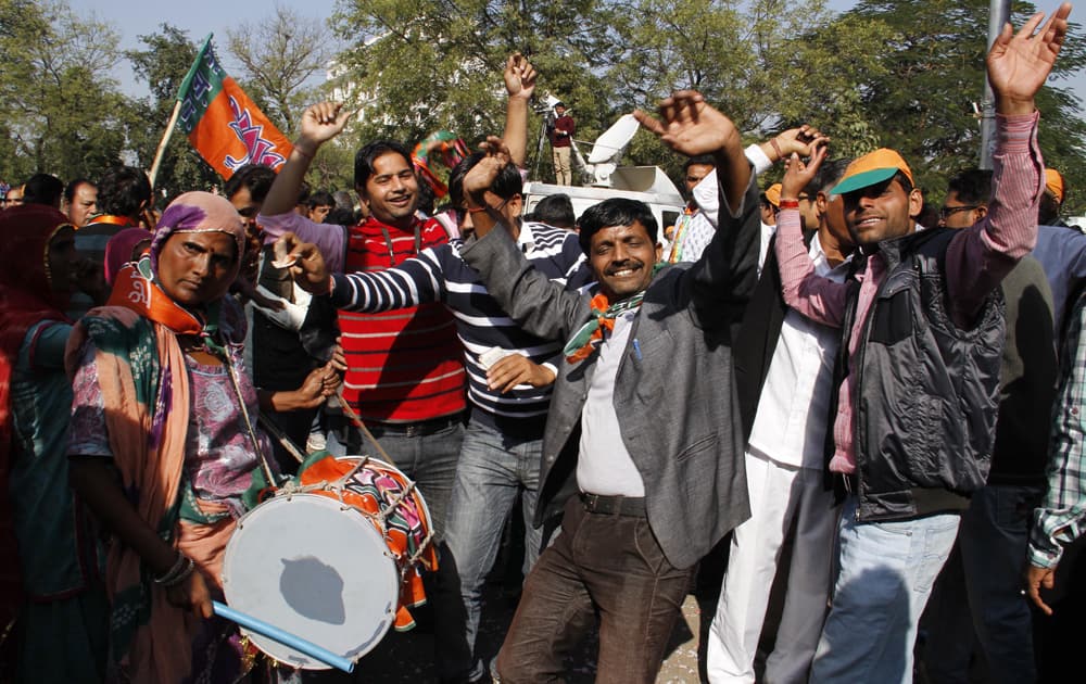 Bharatiya Janata Party (BJP) supporters dance as they celebrate the party’s victory in the Rajasthan state Assembly elections in Jaipur.