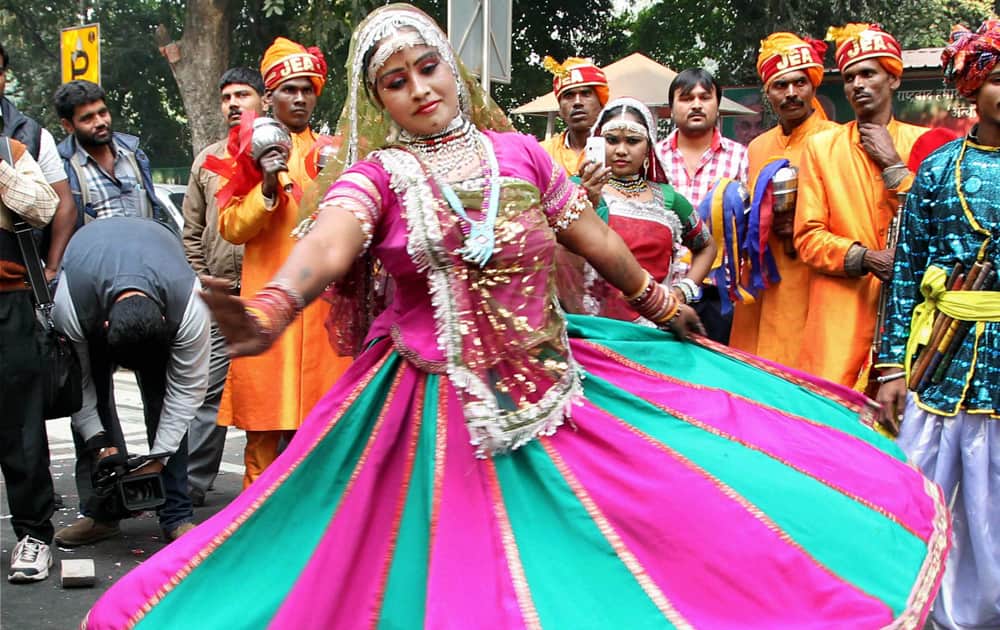 An artist dances as celebrations started at Delhi BJP office after counting trends showed party`s win in Assembly polls, in New Delhi.