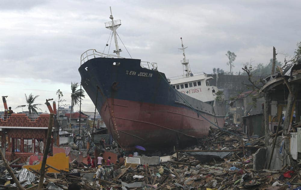A ship, which was washed ashore during Typhoon Haiyan, lies among the debris of destroyed homes in Tacloban, central Philippines.