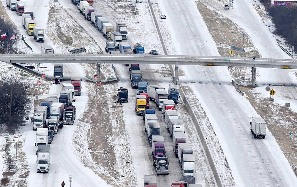 Traffic on IH-35E South bound sits at a complete stop as a tractor trailer North bound sits on the side of the road, in Sanger, Texas.