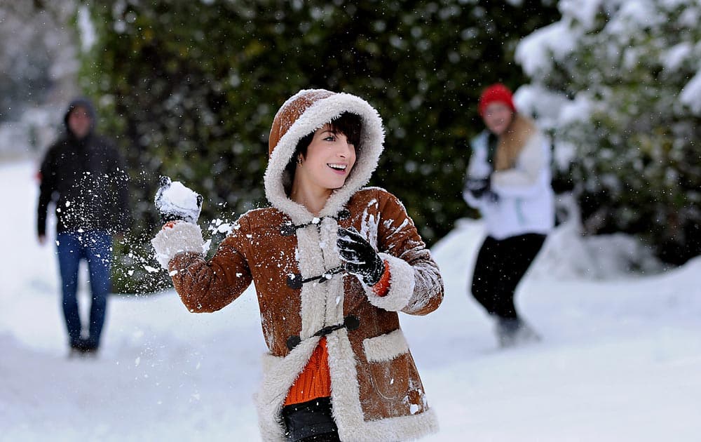 Oregon State University senior Suzy Slack takes aim during a snowball fight with friends in downtown Corvallis, Ore.