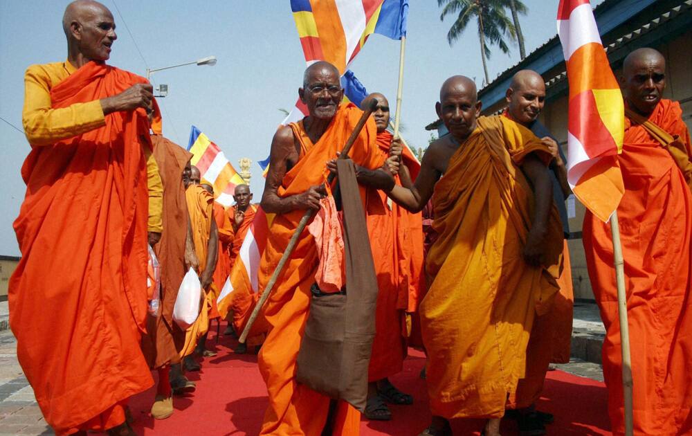 Buddhist monks arrive to pay homage to Bhim Rao Ambedkar on his 58th death anniversary at Chaitya Bhoomi in Mumbai.