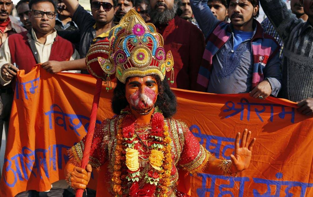 An Indian man dressed as Hindu monkey-God Hanuman stands in front of members of Vishwa Hindu Parishad or World Hindu Council during a protest on the 21st anniversary of the Babri Mosque demolition in Allahabad.