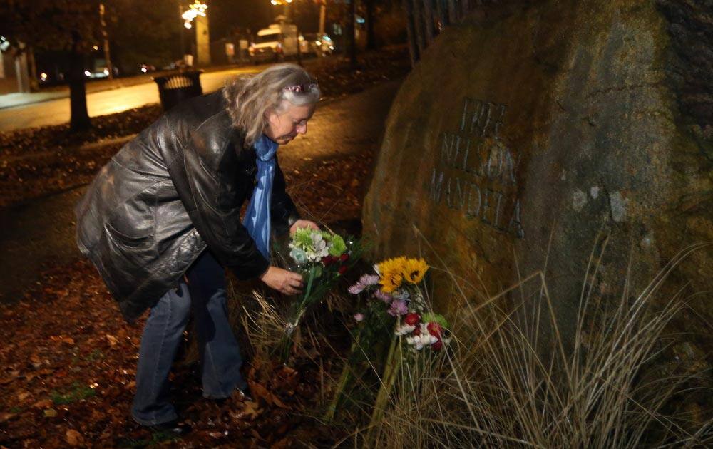 Veronique Pryor, of Inman Park, drops flowers off at the sculpture