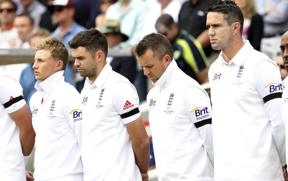 England cricket players from right, Kevin Pietersen, Graeme Swann, James Anderson and Joe Root take a moment of silence for former South African President Nelson Mandela before the start of the second Ashes cricket test match against Australia in Adelaide.