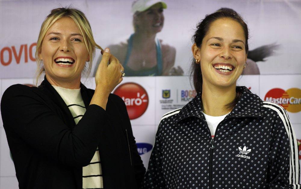 Russian Tennis player Maria Sharapova, left, and Ana Ivanovic from Serbia smile as they pose for photos during a press conference in Bogota, Colombia.