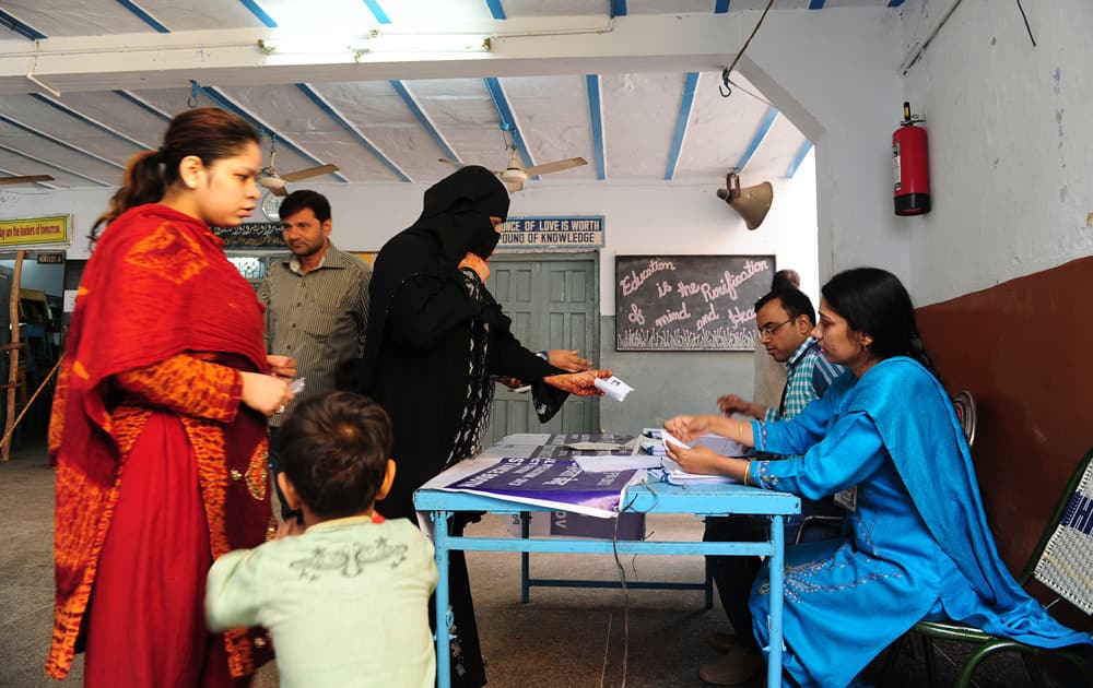 People cast their votes for Delhi Assembly elections, at a polling station in Delhi. Pic Courtesy- DNA