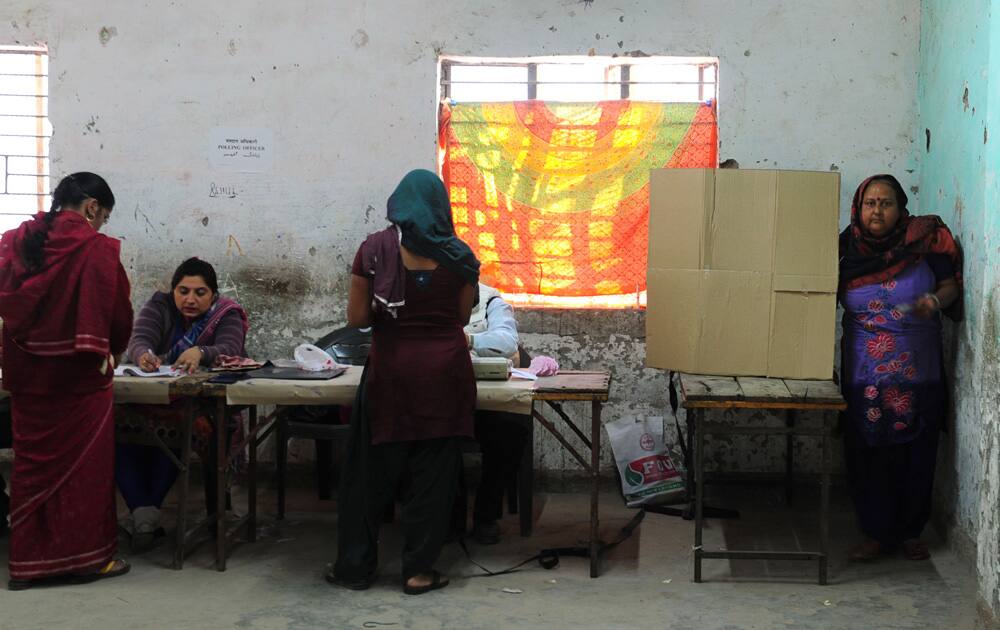 People cast their votes for Delhi Assembly elections, at a polling station in Delhi. Pic Courtesy- DNA