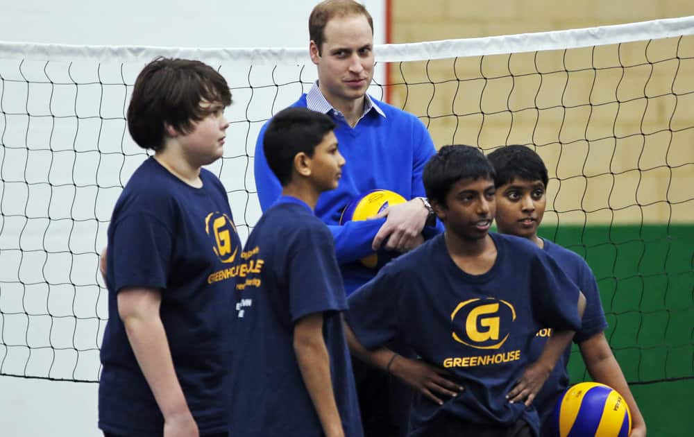 Britain`s Prince William, the Duke of Cambridge, pauses during a game of volleyball with children during a Coach Core apprentice training program session at Westway Sports Centre, in London.