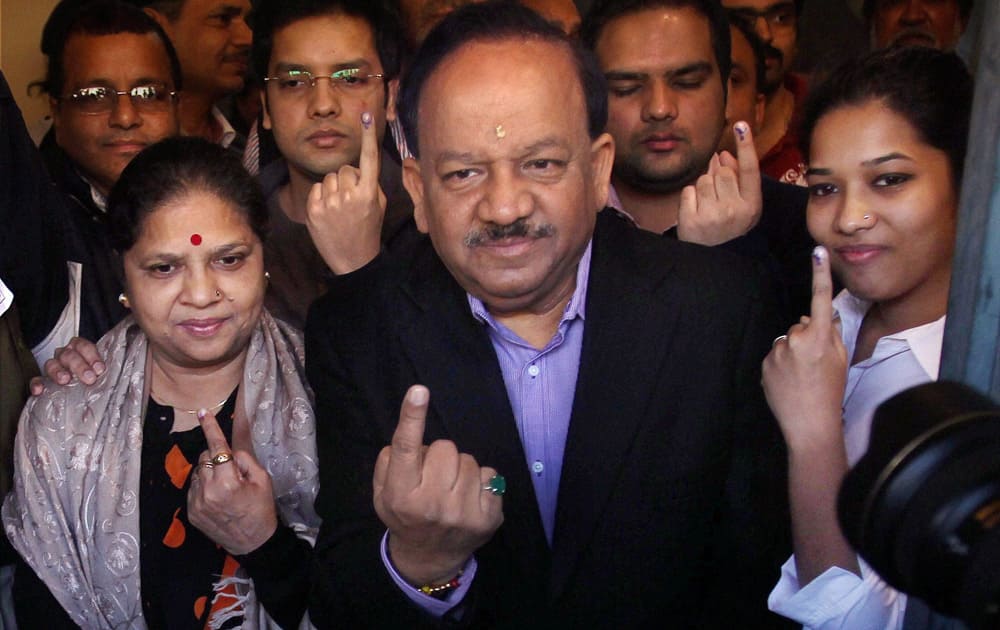 BJP`s CM candidate Harsh Vardhan with family members after casting their votes for Delhi Assembly elections, at a polling station in East Delhi.