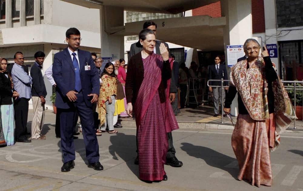 UPA Chairperson Sonia Gandhi with Delhi Chief Minister Sheila Dikshit after casting votes for Delhi Assembly elections at Nirman Bhawan polling station in New Delhi.