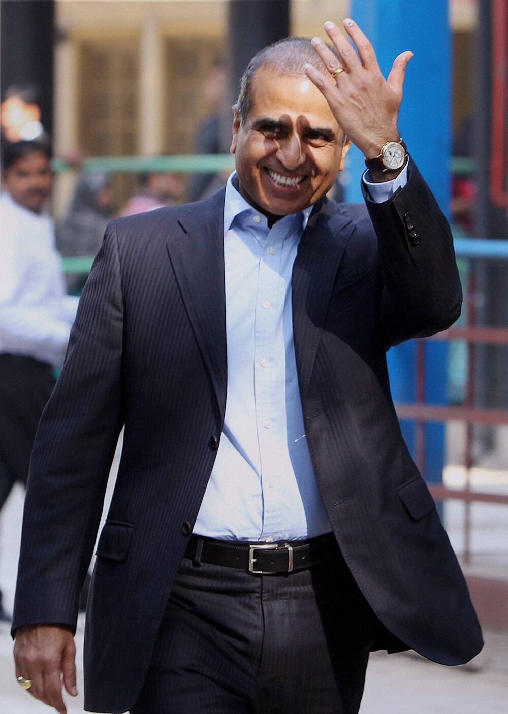 Industrialist Sunil Bharti Mittal shows his ink-marked finger after casting his vote for Delhi Assembly elections at a polling station in New Delhi.