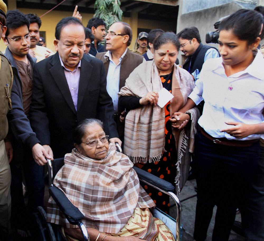BJP`s CM candidate Harsh Vardhan with family members after casting their votes for Delhi Assembly elections, at a polling station in East Delhi.