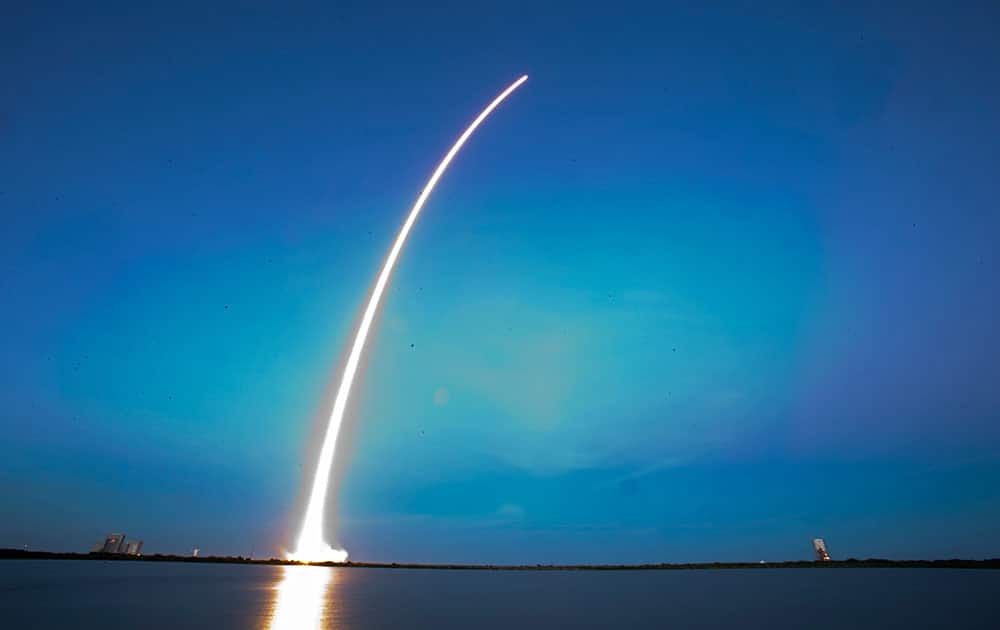 A Falcon 9 SpaceX rocket lifts off from Launch Complex 40 at the Cape Canaveral Air Force Station in Cape Canaveral, Fla. The rocket is carrying its first commercial payload, a communications satellite.