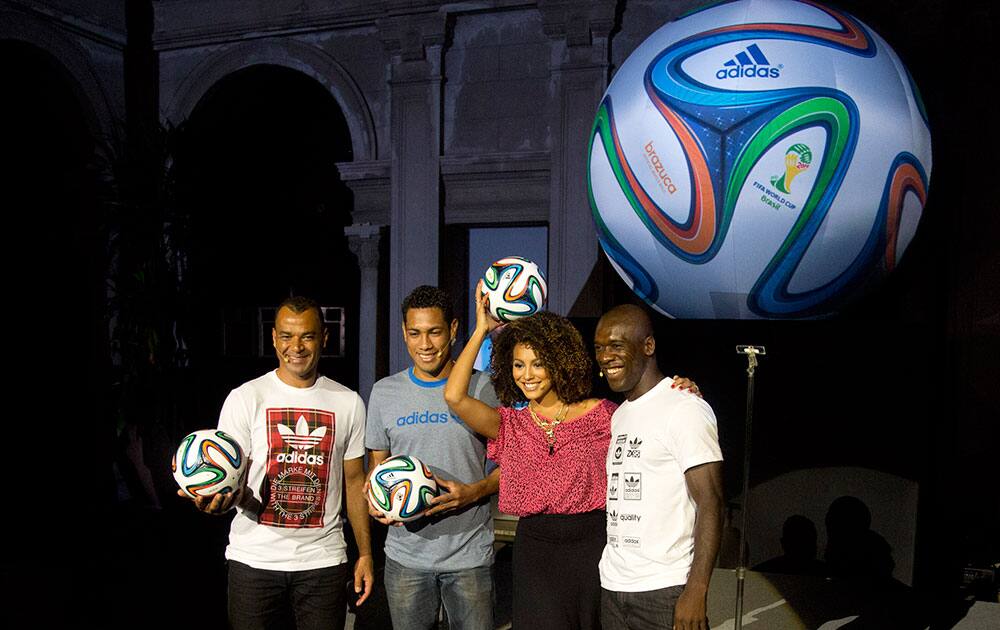 From right, Dutch soccer player Clarence Seedorf, Brazilian model Sheron Menezes, Brazilian soccer player Hernanes and former Brazilian player Cafu pose holding the 2014 World Cup official soccer ball, called Brazuca, after it was unveiled in Rio de Janeiro, Brazil.