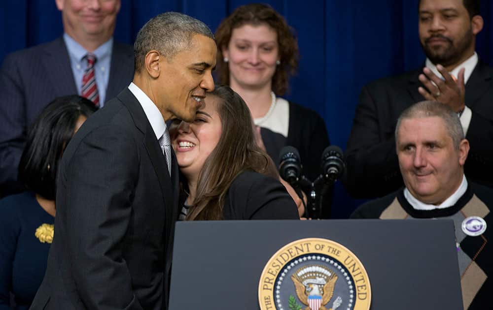 President Barack Obama embraces Monica Weeks after she spoke about the new health care law, in the South Court Auditorium in the Eisenhower Executive Office Building on the White House complex in Washington.