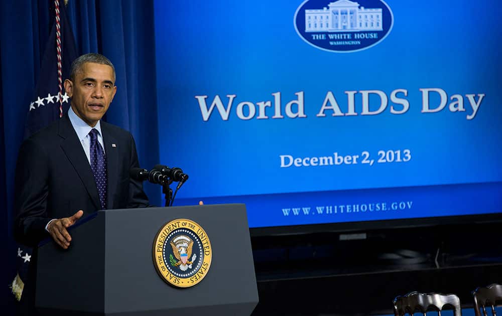 President Barack Obama gestures while speaking at a world AIDS Day event, in the South Court Auditorium on the White House complex in Washington.