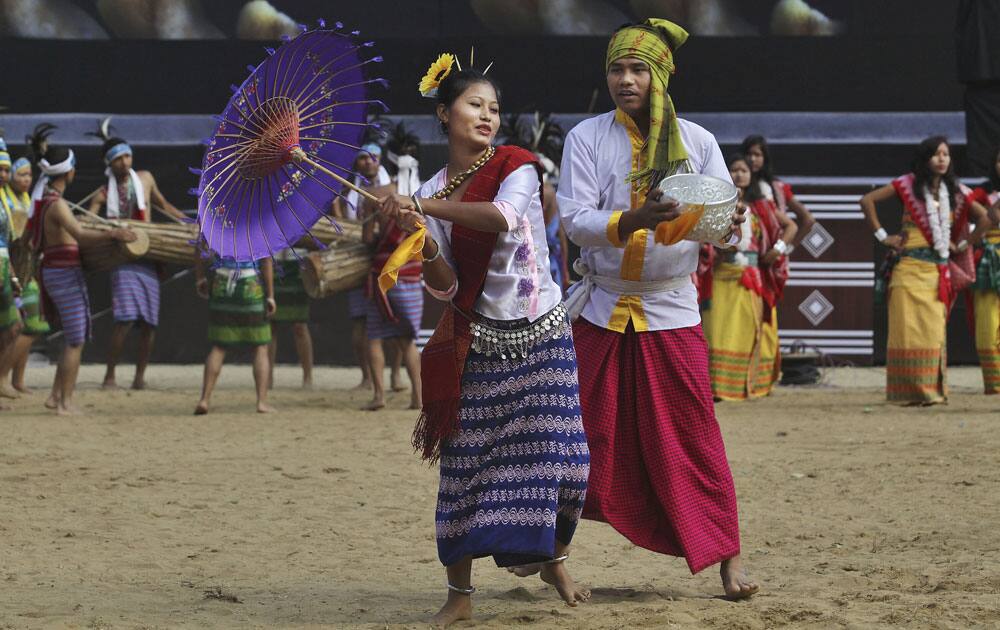 Tribal dancers from Tripura in traditional attire perform a dance during the Hornbill festival at Kisama village on the outskirts of Kohima, Nagaland.