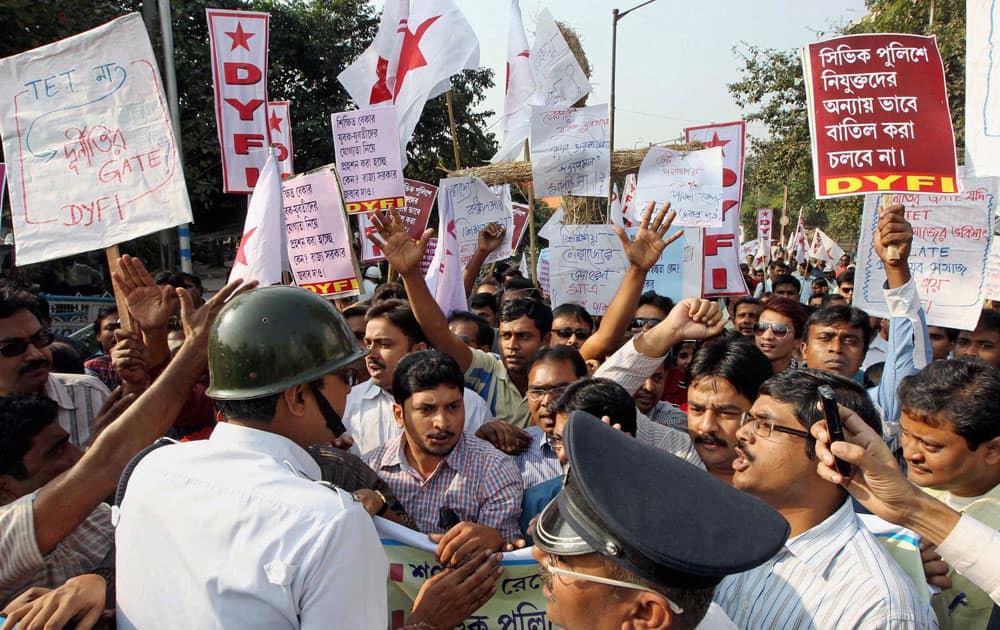Police personnel try to stop the DYFI activists during their protest against the State Government in Kolkata.