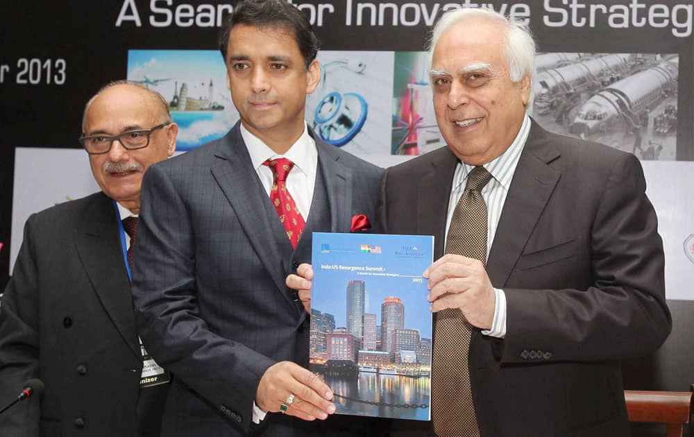 Union Minister for Communications and IT Kapil Sibal with Rohit Kochar, CEO of Kochar & Kochar, releases an IACC study book.