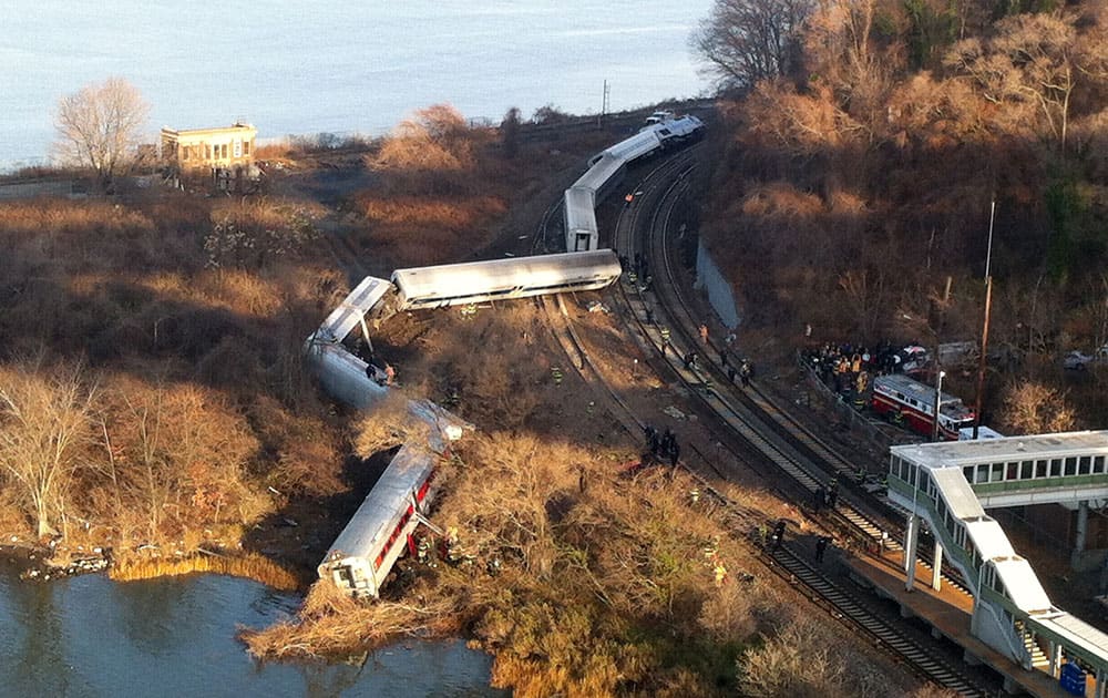 Cars from a Metro-North passenger train are scattered after the train derailed in the Bronx borough of New York.