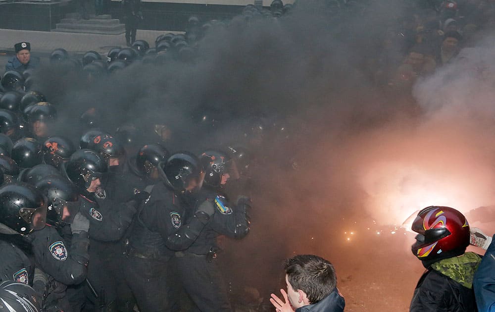 Smoke goes up as protesters clash with police outside the presidential office in Kiev, Ukraine.