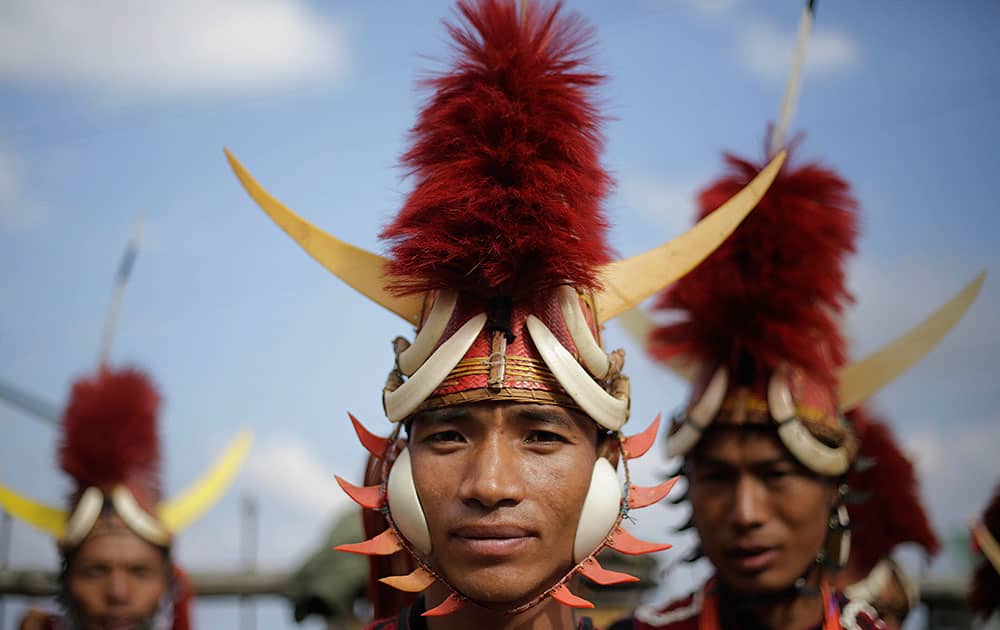 A Naga dancer in traditional attire waits to perform during the opening day of the Hornbill festival at Kisama village on the outskirts of Kohima, Nagaland, India.