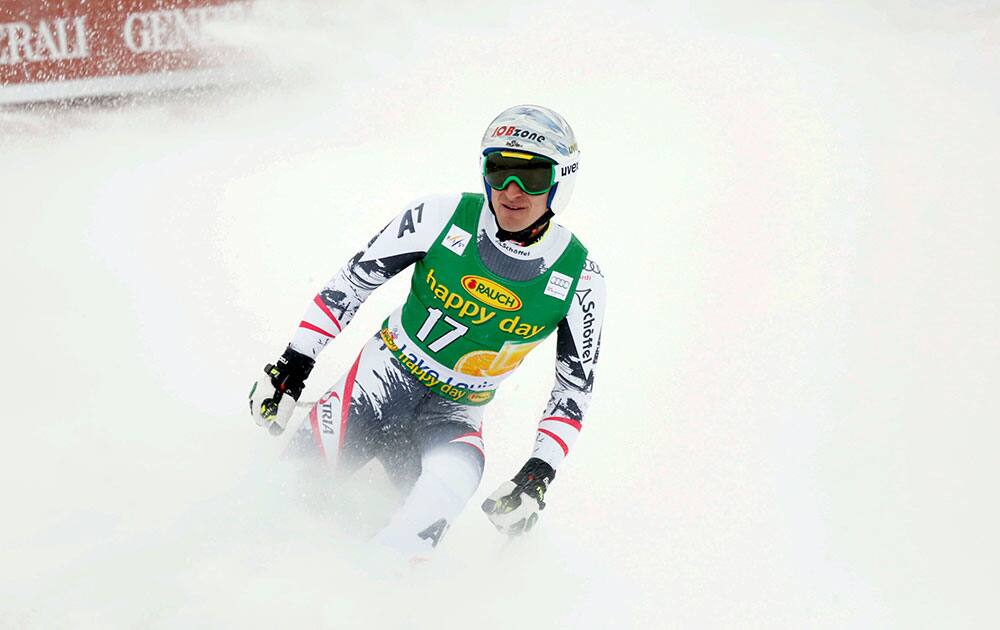 Matthias Mayer, of Austria, stands in the finish area following his run at the men`s World Cup super-G ski race in Lake Louise, Alberta.
