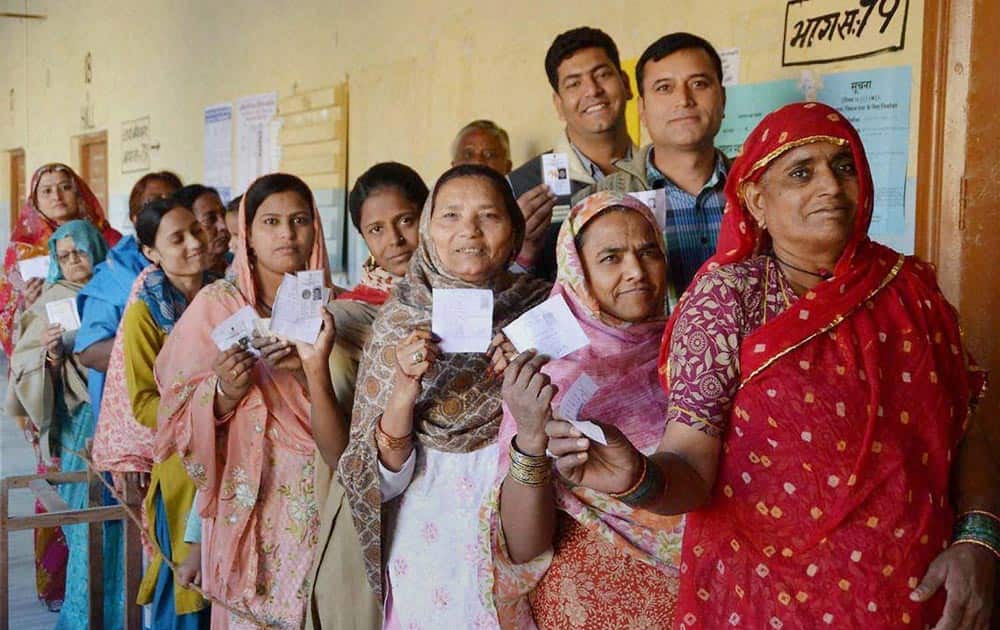 Women wait in a queue to cast their votes at a polling station in Bikaner during Rajasthan Assembly polls.