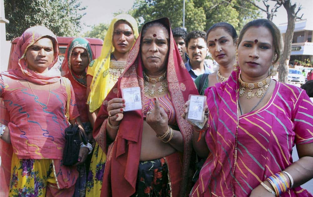 Eunuchs showing their voter id cards for Rajasthan assembly elections at a polling booth in Jodhpur.
