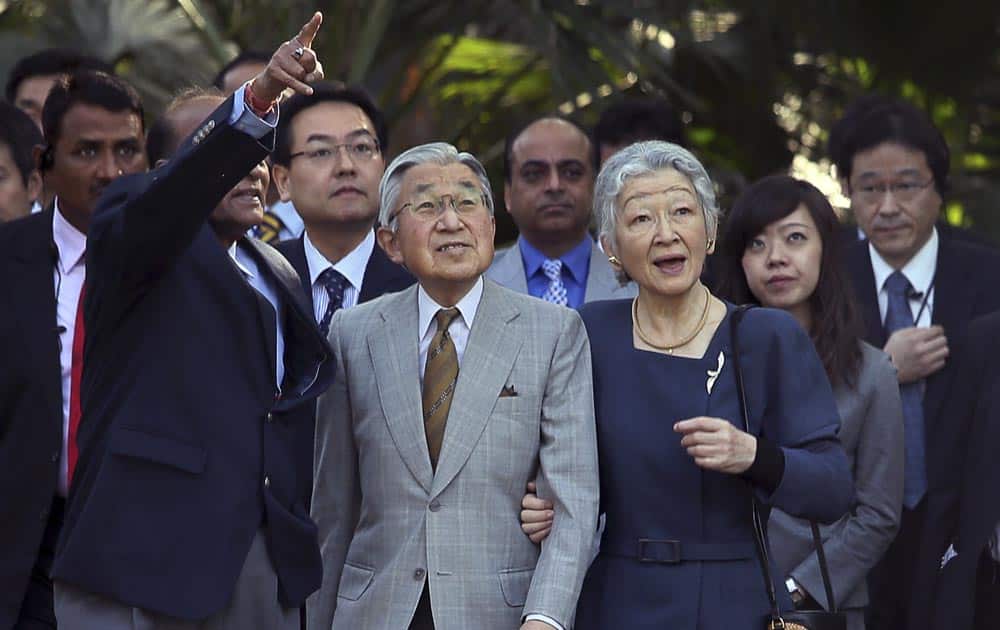 Japan`s Emperor Akihito, center, and Empress Michiko take a walk in Lodhi garden, home to 15th and 16th century tombs of Mughal emperors, in New Delhi.