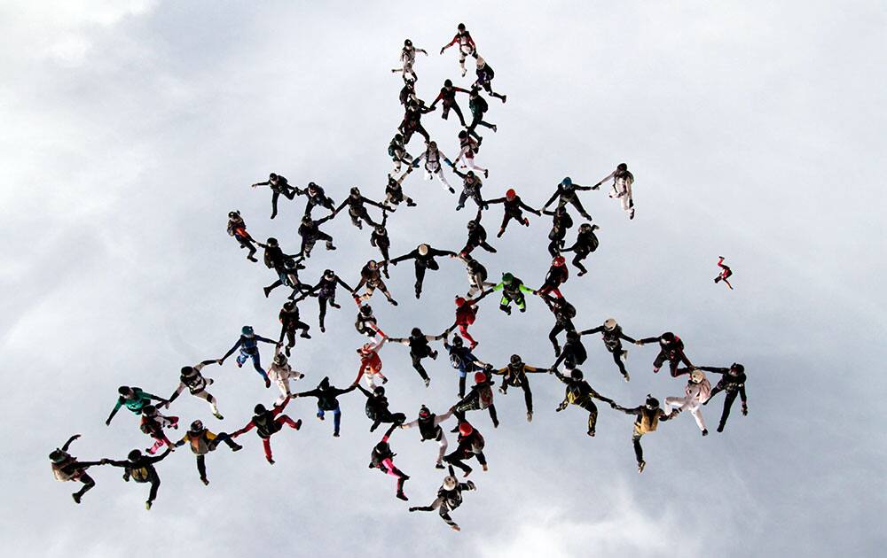 This image provided by Niklas Daniel shows 63 women skydivers setting a new world record for the largest all-female formation while jumping head down in Eloy, Aria.