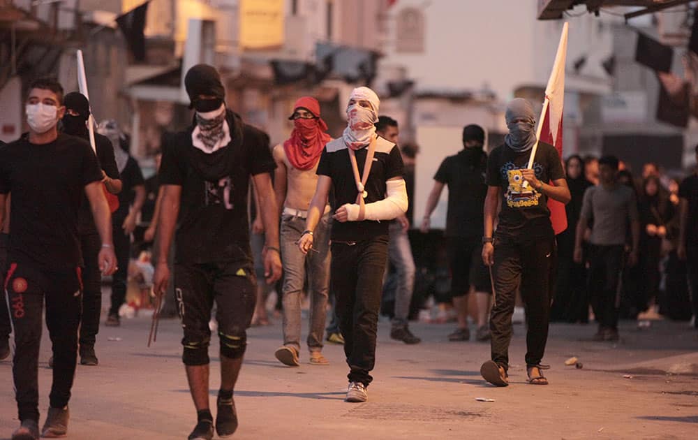 Bahraini youths walk to confront riot police after the politically charged funeral for Ahmad Abdul Amir, 15, on the edge of Manama, Bahrain.