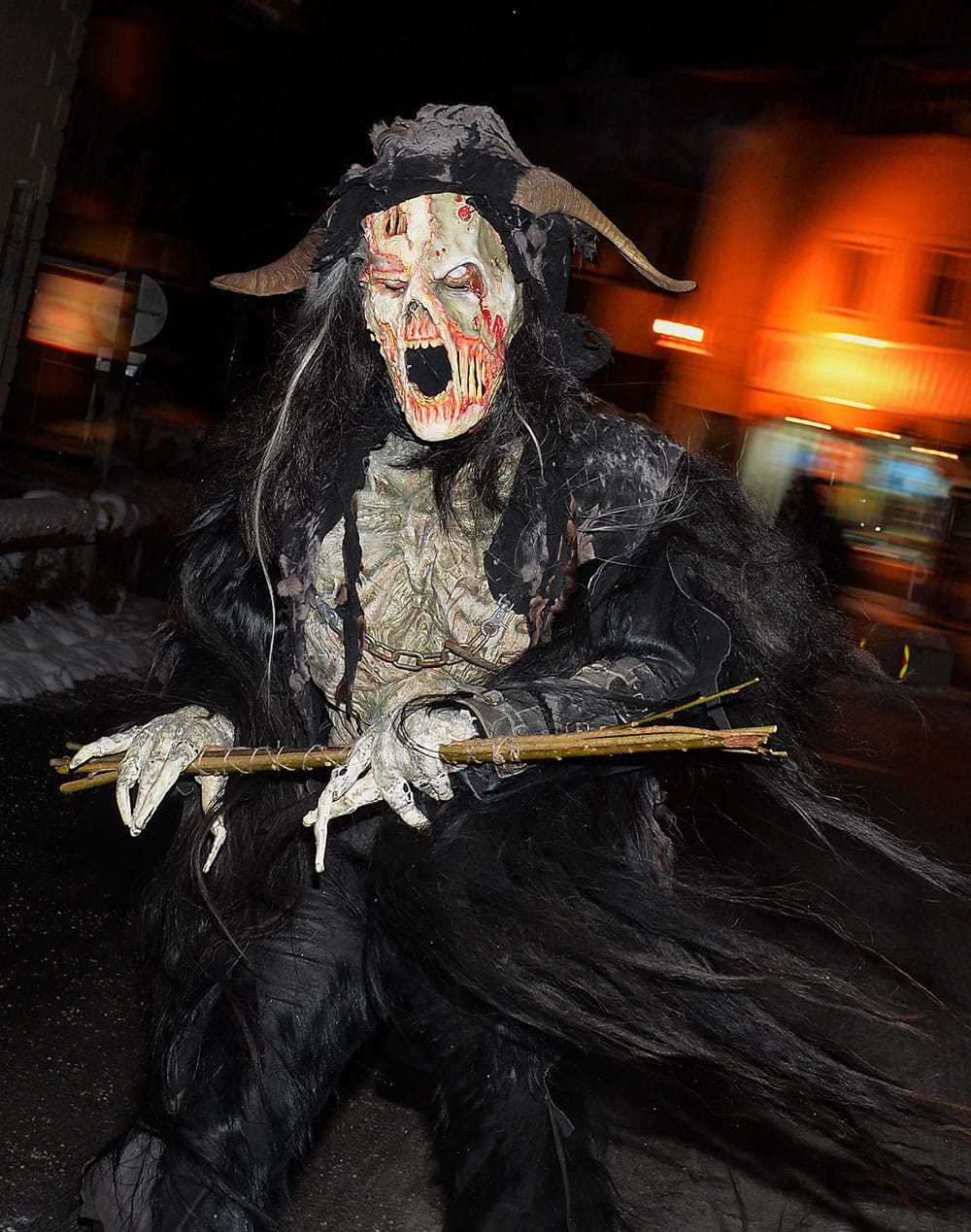 A man dressed as a Krampus, the companion of St. Nicholas and one of Austria`s unique Advent traditions, makes his way during a traditional Krampus procession in Lofer, Austrian province of Salzburg.