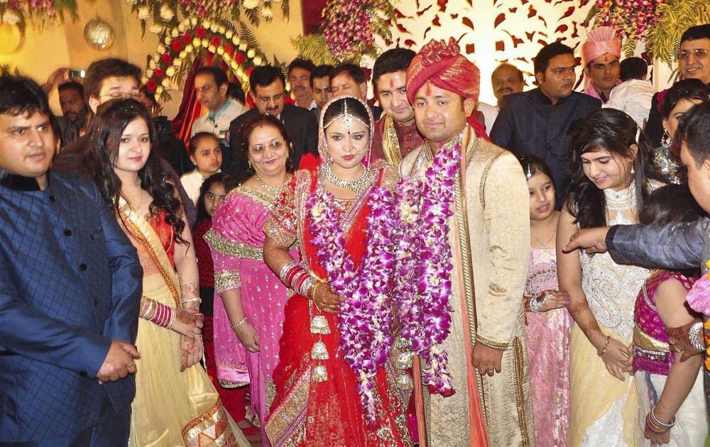 Indian leg-spinner Piyush Chawla and Anubhuti Chauhan posing for photographers during their wedding ceremony in Moradabad.