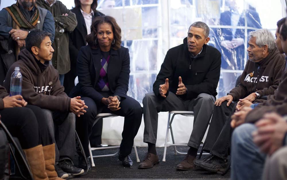 President Barack Obama and first lady Michelle Obama visit with individuals who are taking part in Fast for Families on the National Mall in Washington.