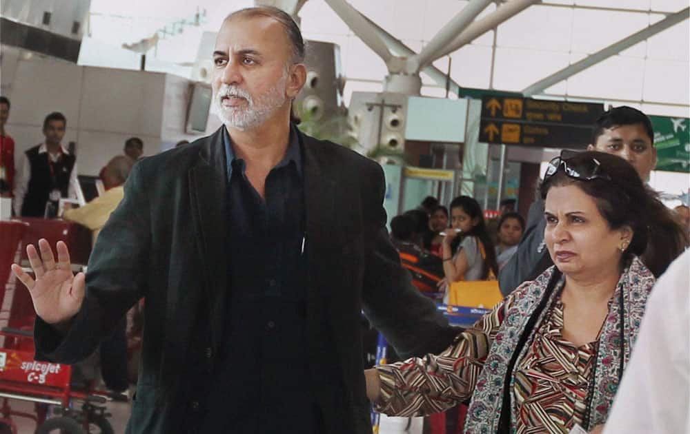 Tehelka editor-in-chief Tarun Tejpal with his wife at the Indira Gandhi International Airport in New Delhi on Friday before boarding flight to Goa. Tejpal is accused of sexually assaulting a woman journalist.