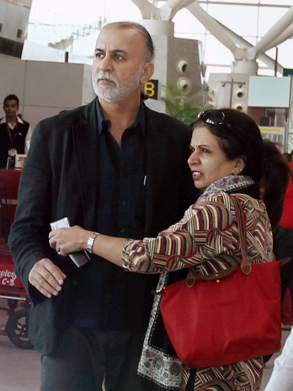 Tehelka editor-in-chief Tarun Tejpal with his wife at the Indira Gandhi International Airport in New Delhi on Friday before boarding flight to Goa.