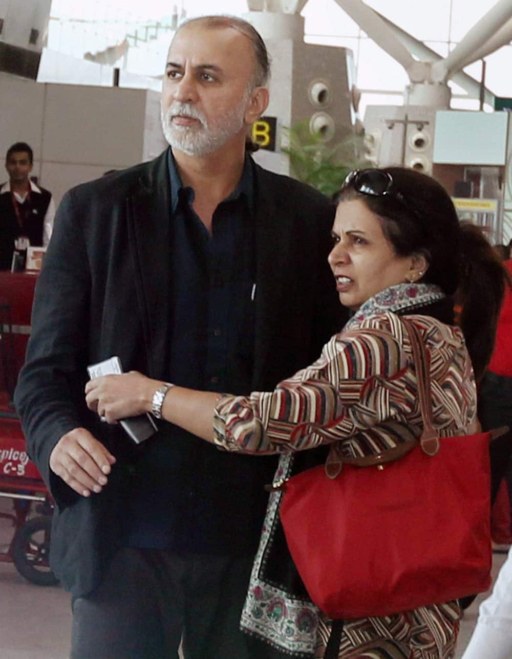 Tehelka editor-in-chief Tarun Tejpal with his wife at the Indira Gandhi International Airport in New Delhi on Friday before boarding flight to Goa. Tejpal is accused of sexually assaulting a woman journalist.